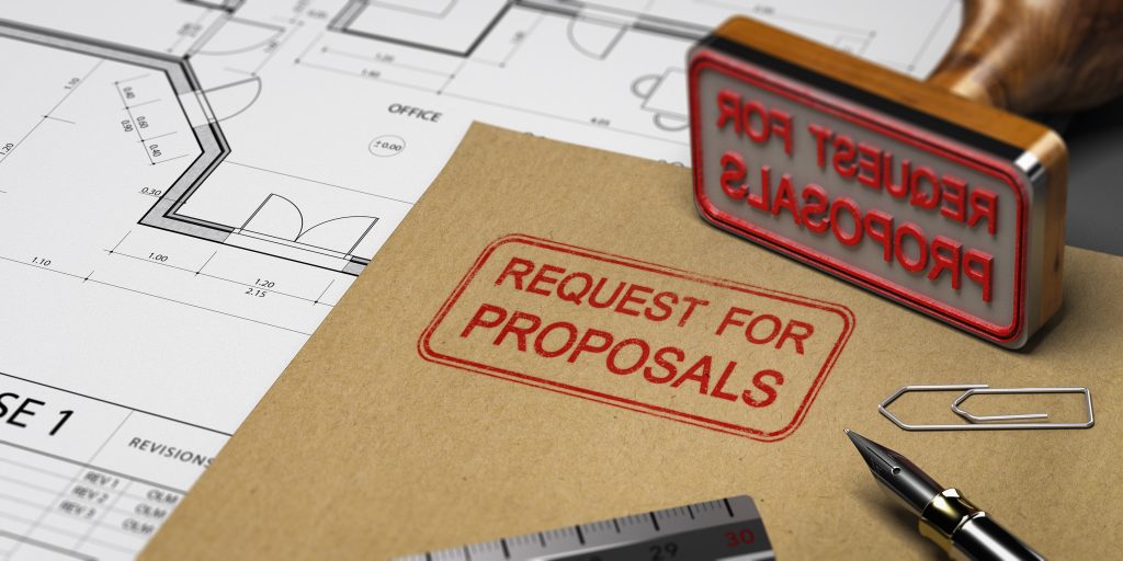 A stamp reading "Request for Proposals" surrounded by building drawings, a ruler, pen, and paperclip.